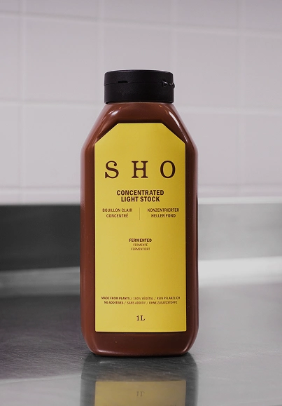 SHO Concentrated Light Stock bottle labeled as culinary base on a kitchen counter