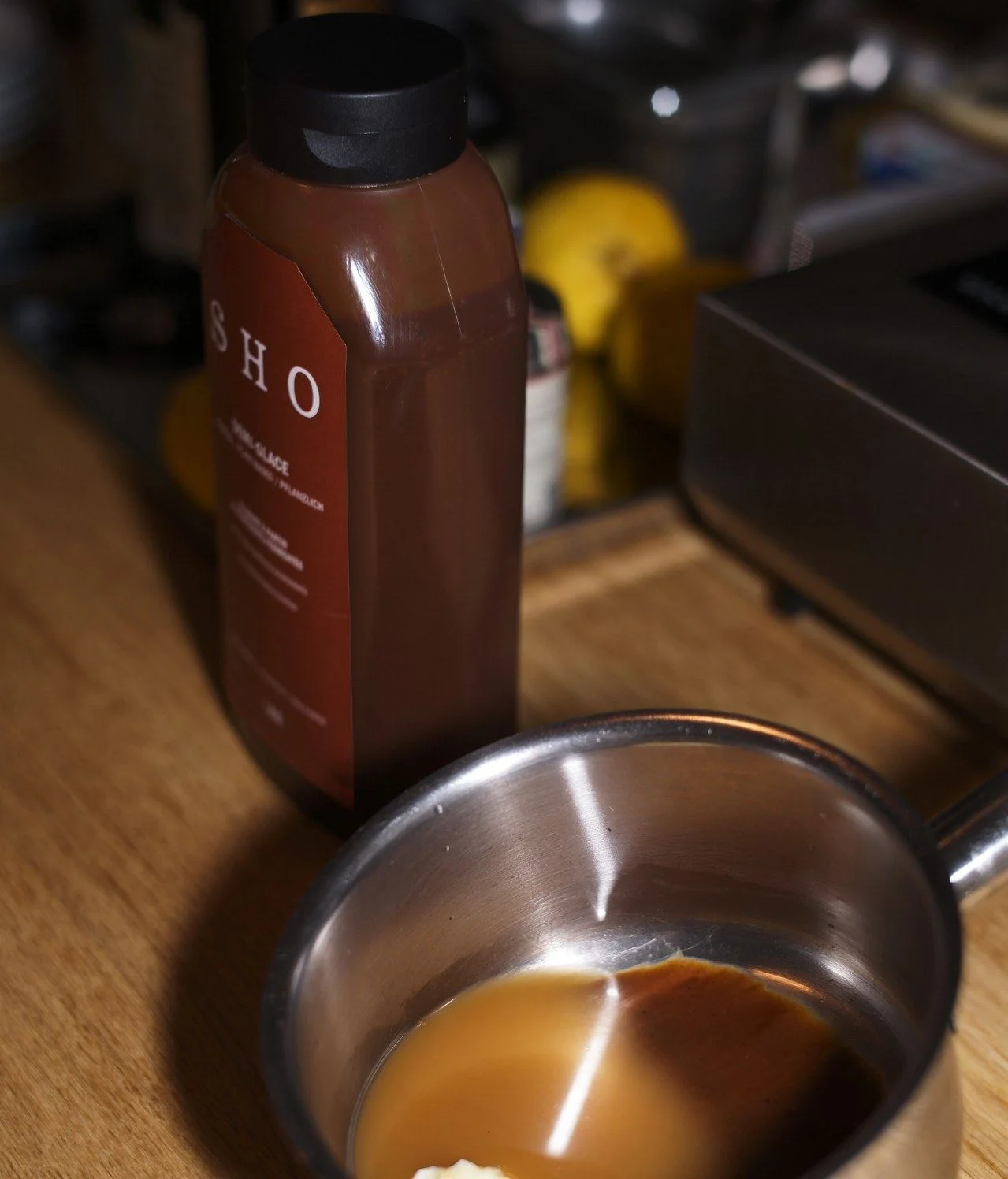 Bouteille de demi-glace SHO près d'une petite casserole sur un comptoir en bois, conseils de conservation