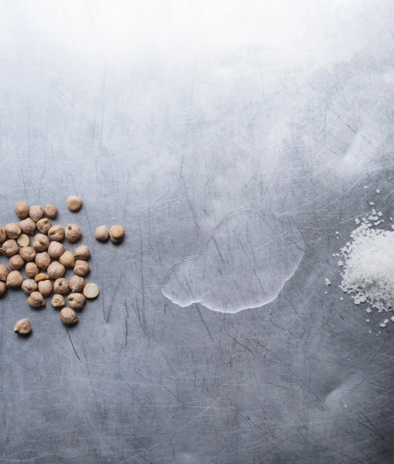 Raw chickpeas on a grey surface representing a real food solution for food industrials
