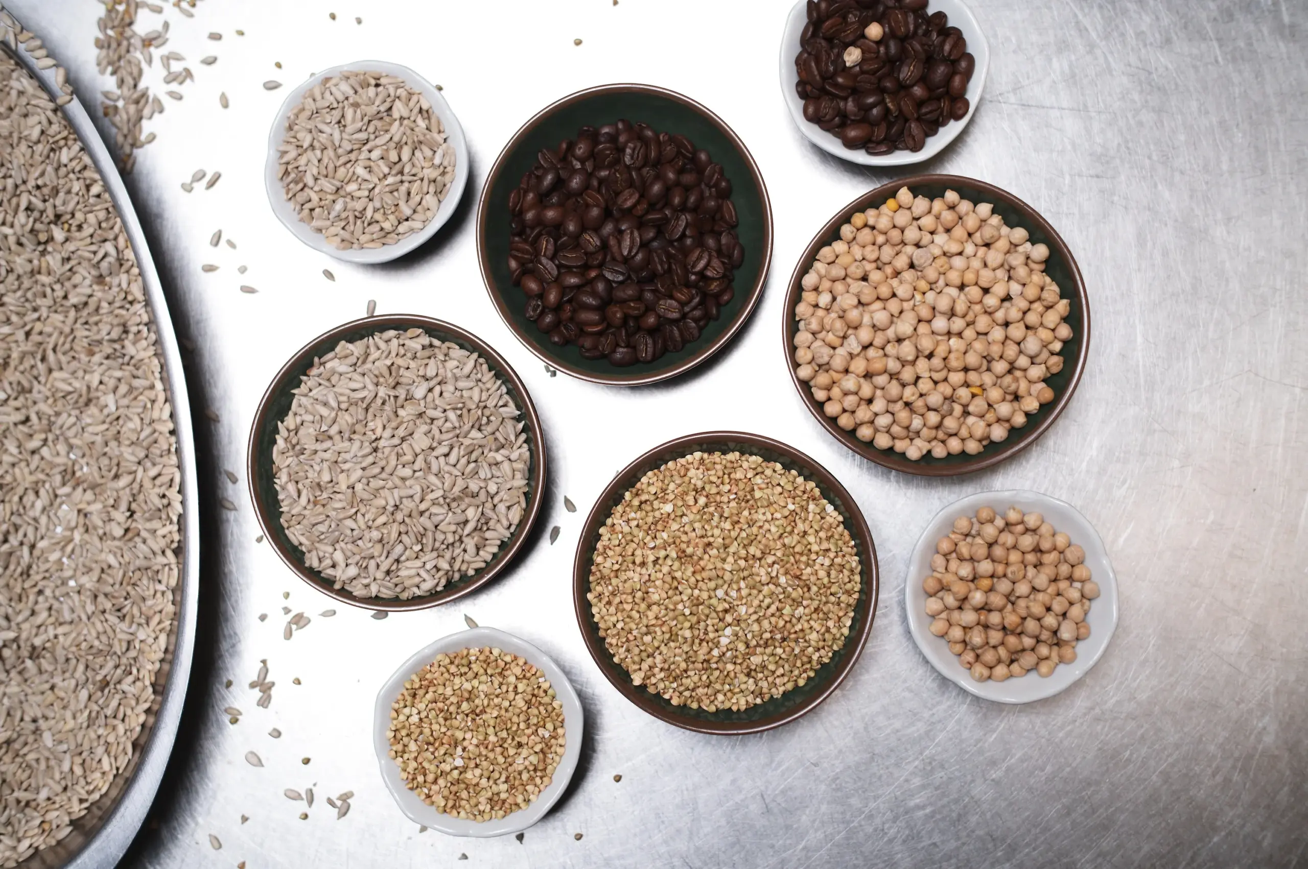Top-view assortment of grains, legumes, and sunflower seeds used for natural fermentation and real food flavour.